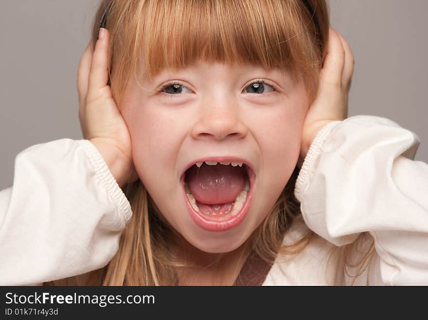 Portrait of an Adorable Red Haired Girl on a Grey Background.