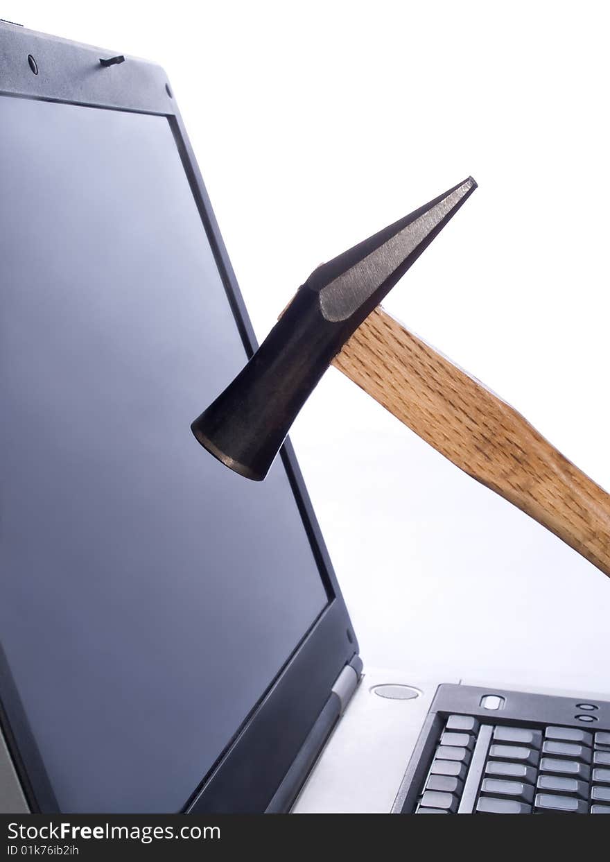 Hammer breaking laptop screen - informational poisoning stress concept. Hammer breaking laptop screen - informational poisoning stress concept