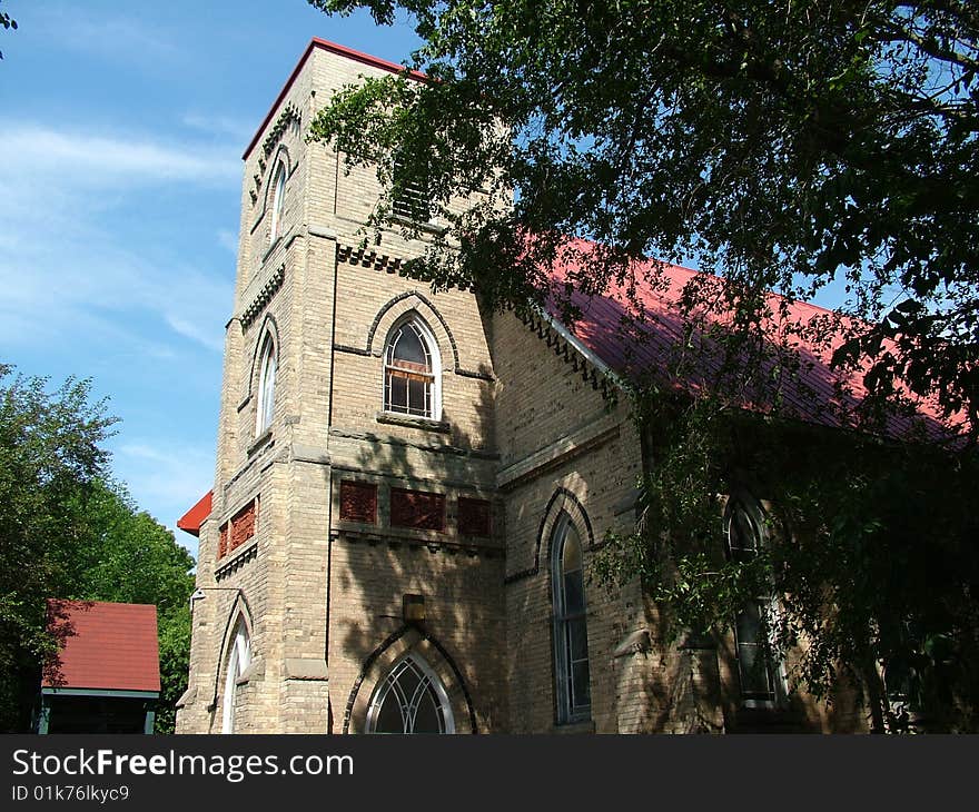 An old church in the woods, doors are open for prayers.