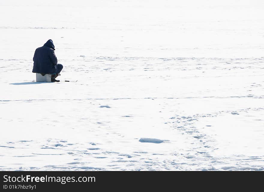 Fisherman on an ice