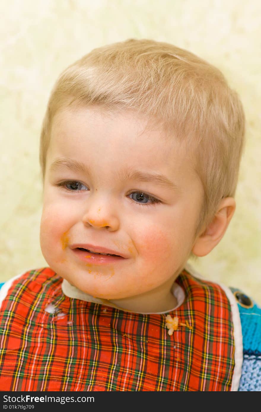 Sad little boy stained with squash