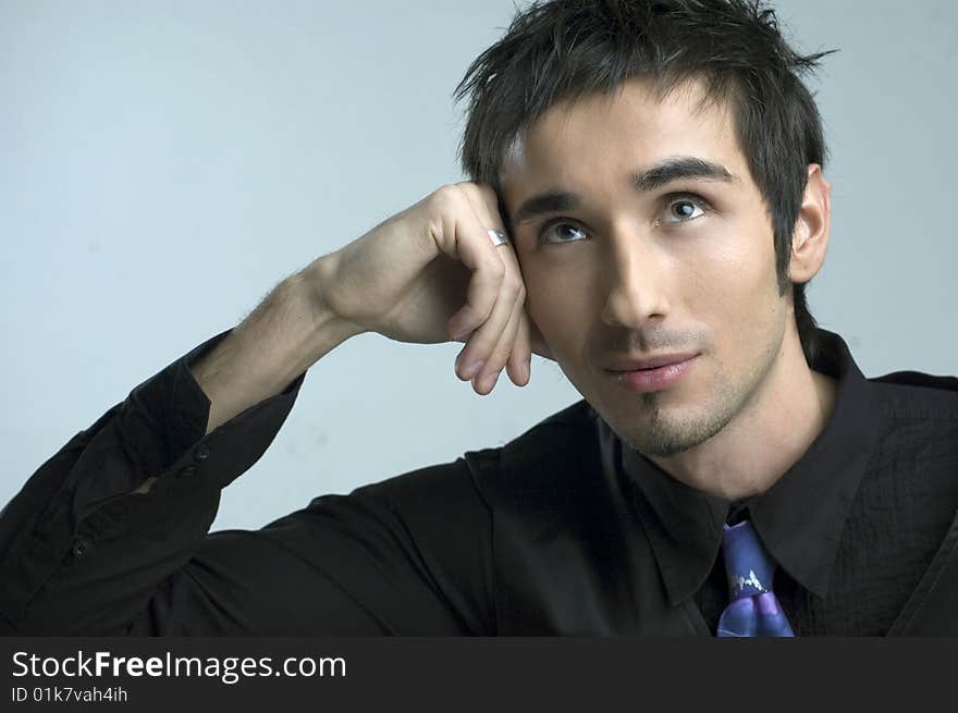 Handsome young man portrait in black suit  in studio