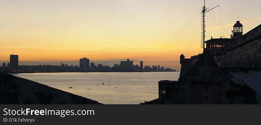 A view of Havana bay and skyline at sunset from spanish fortress El Morro. A view of Havana bay and skyline at sunset from spanish fortress El Morro