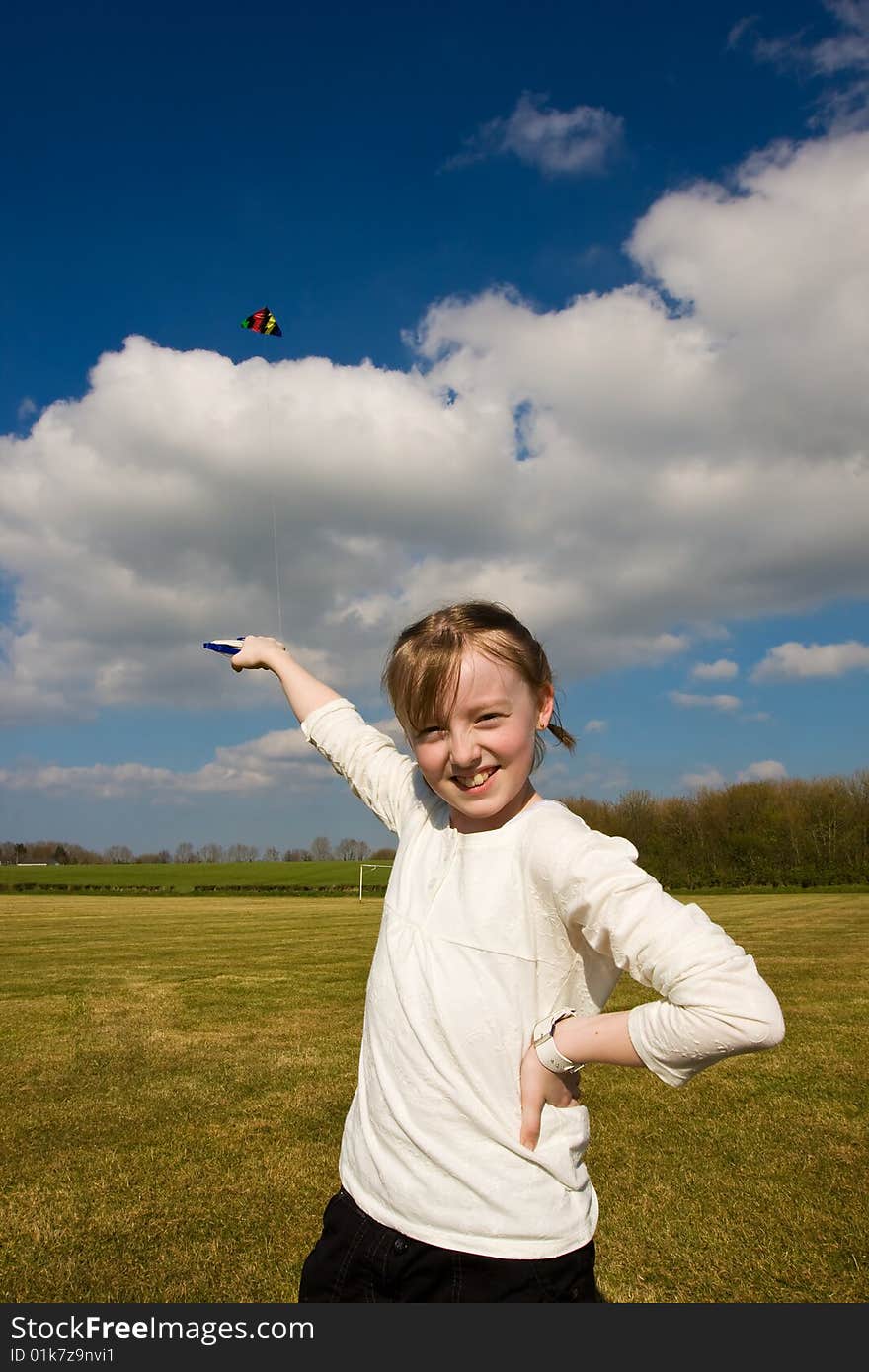 Young girl playing with kite poses for camera. Young girl playing with kite poses for camera