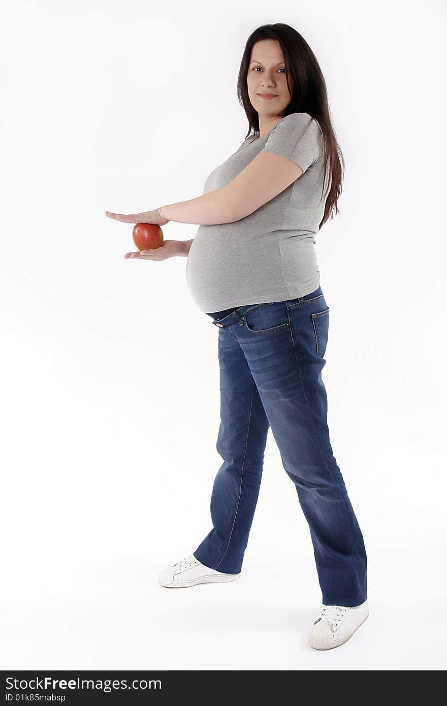 Pregnant woman with red apple isolated on white back ground