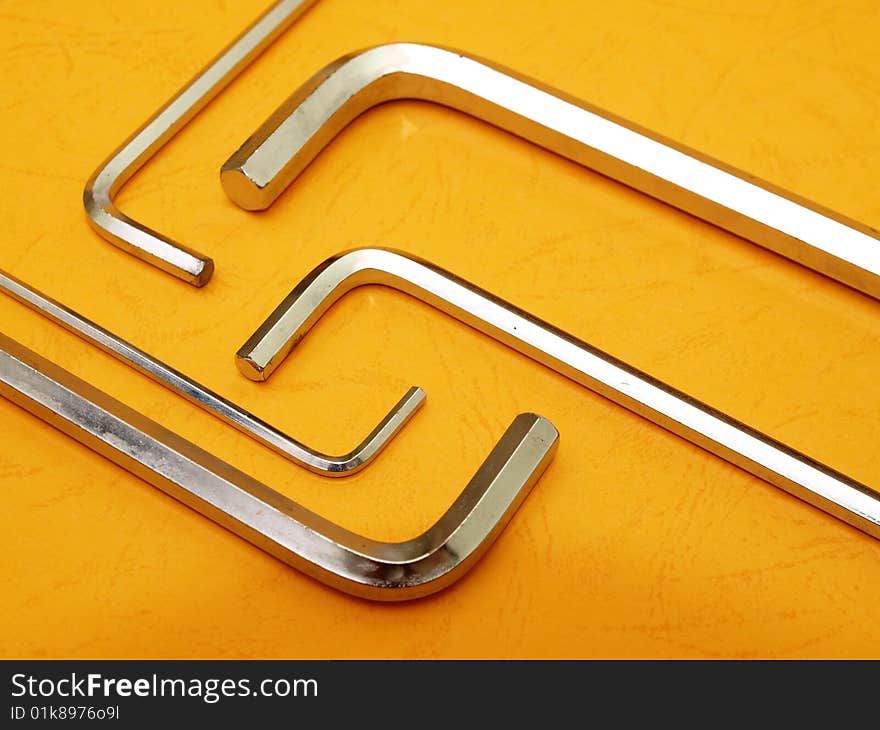 Five hex key set over contrasting orange background. Five hex key set over contrasting orange background