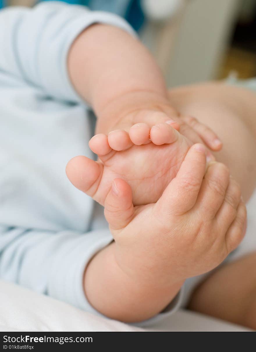 The child playing with his leg