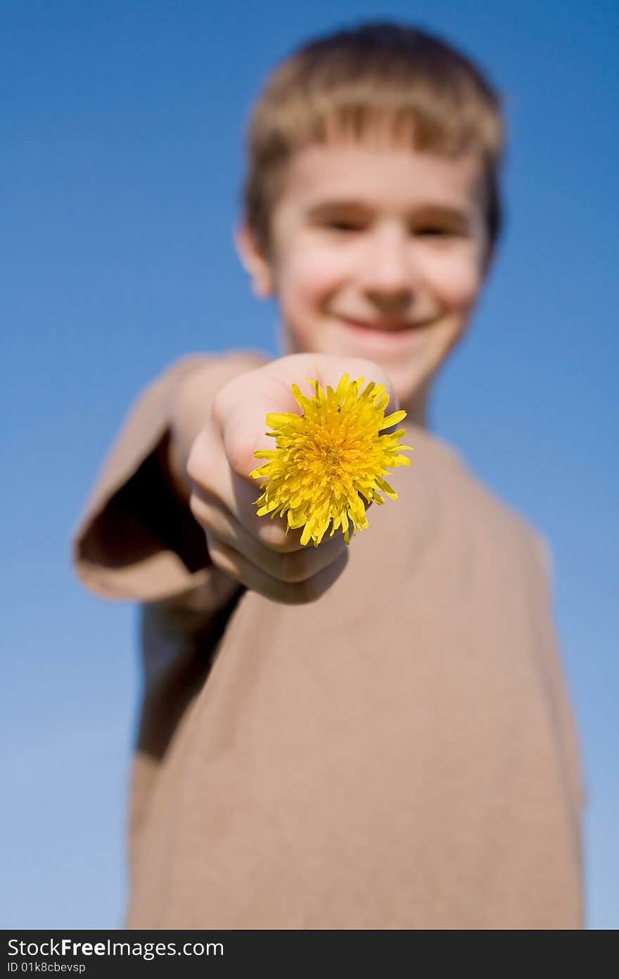 A Cute Boy Holding a Dandelion with Big Smile