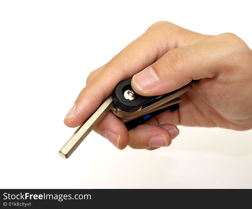 Pocket cyclist hex key in male hand on white background. Pocket cyclist hex key in male hand on white background