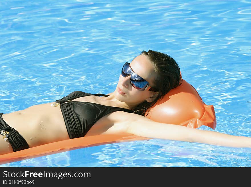 Woman on the air mattress in the swimming pool. Woman on the air mattress in the swimming pool