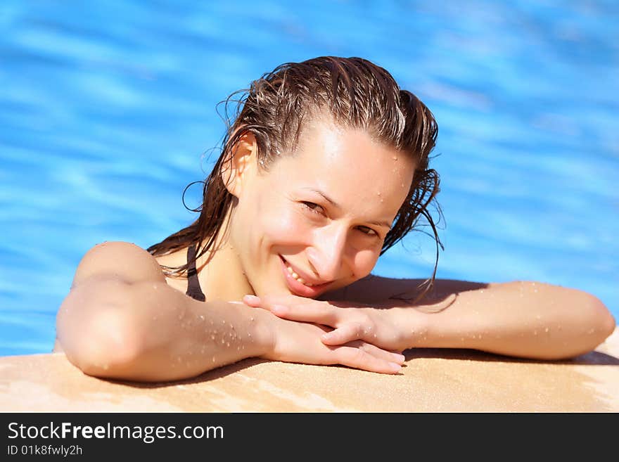 Woman relaxing in the swimming pool. Woman relaxing in the swimming pool