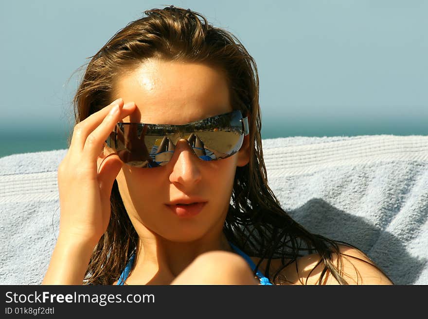 Woman in sunglasses on the beach