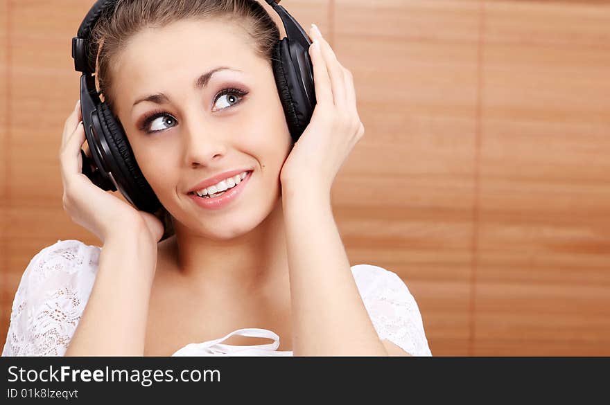 Young sexy women listening music in headphones