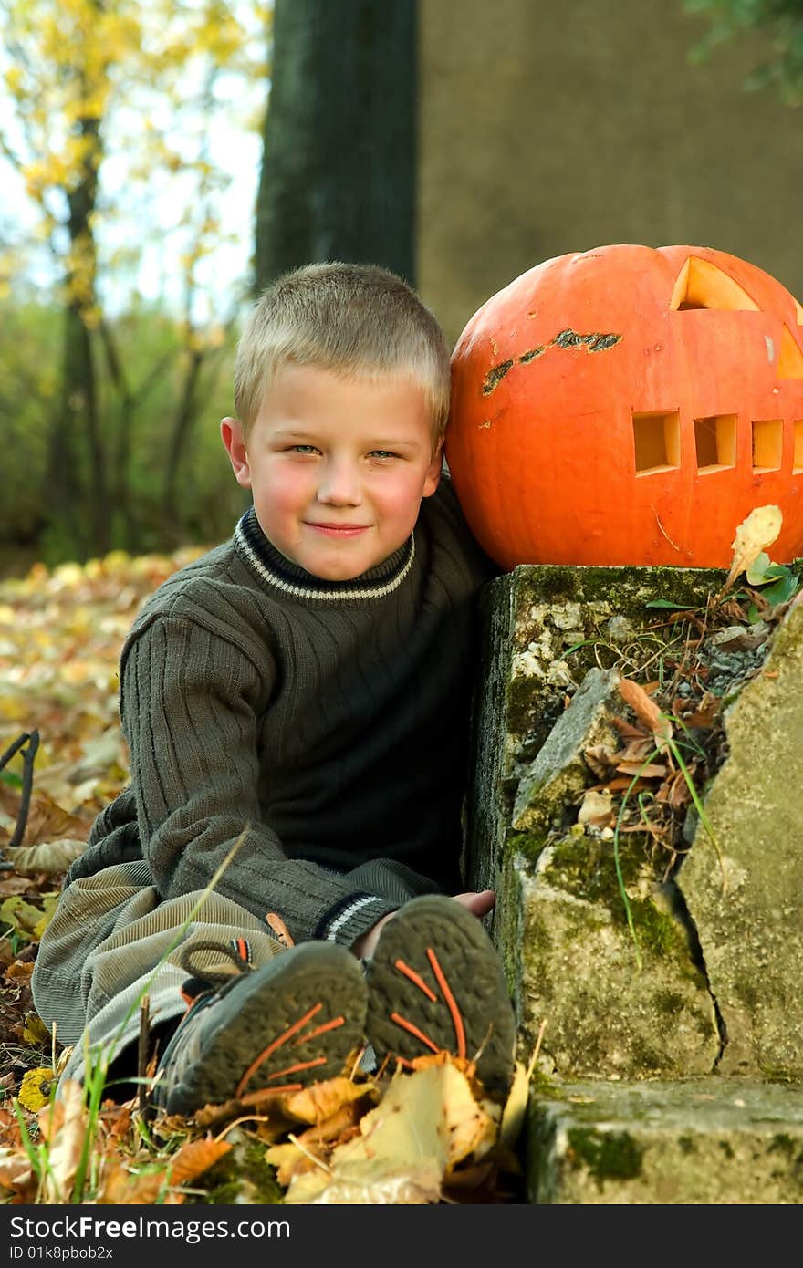 Sitting little boy with halloween pumpkin. Sitting little boy with halloween pumpkin