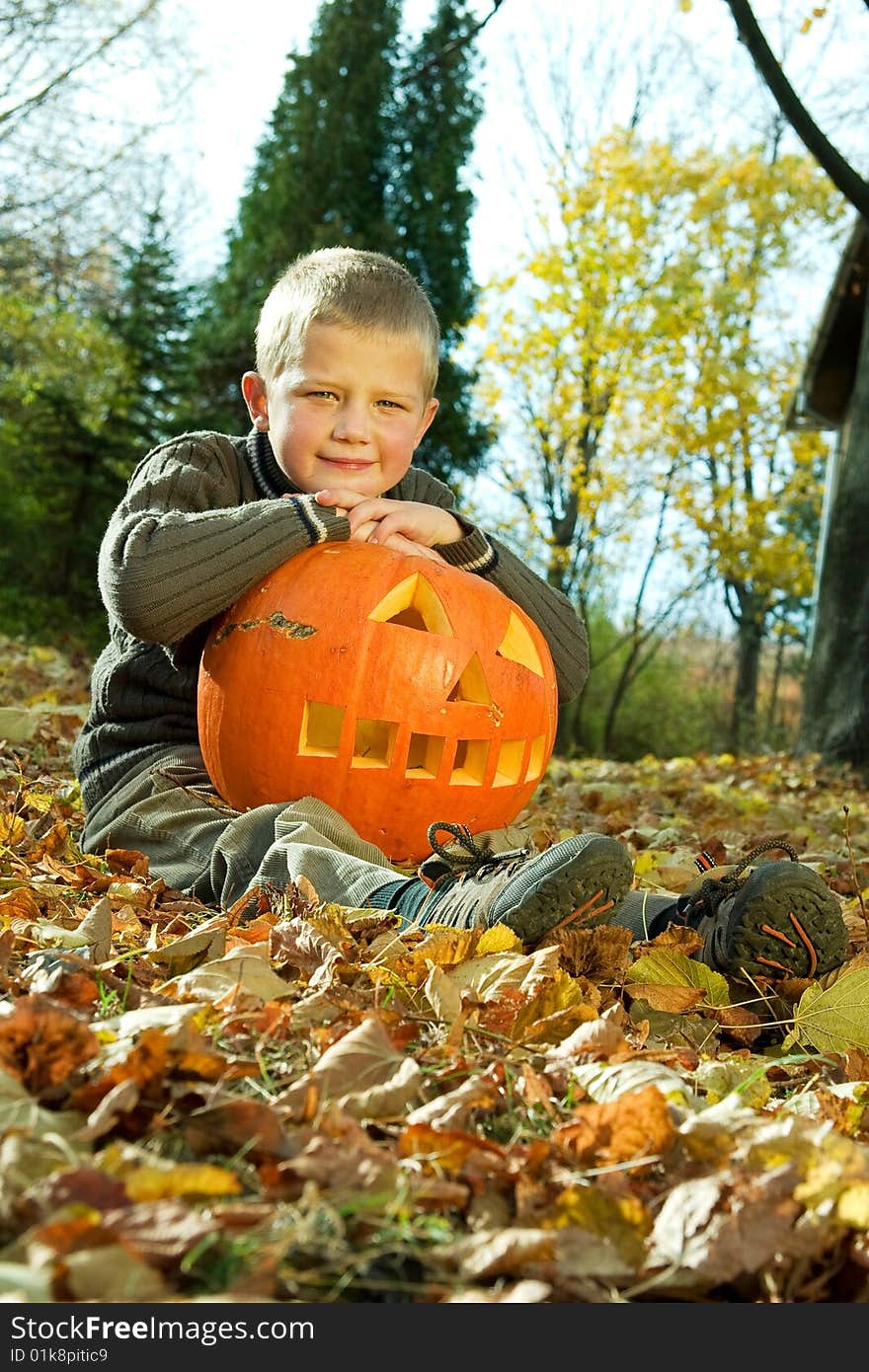 Sitting little boy with halloween pumpkin. Sitting little boy with halloween pumpkin