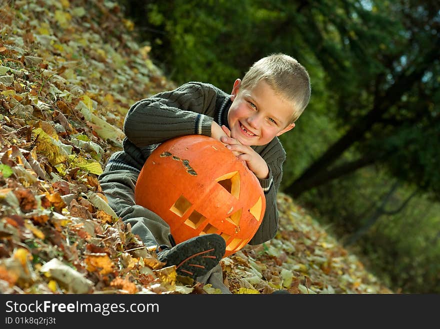 Smiling little boy with halloween pumpkin. Smiling little boy with halloween pumpkin