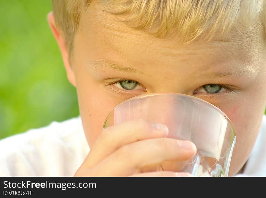 Shot of a boy drinking a glass of fresh orange juice. Shot of a boy drinking a glass of fresh orange juice