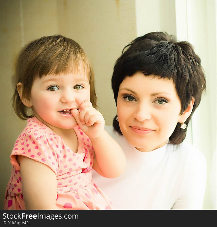 Mother with daughter near window