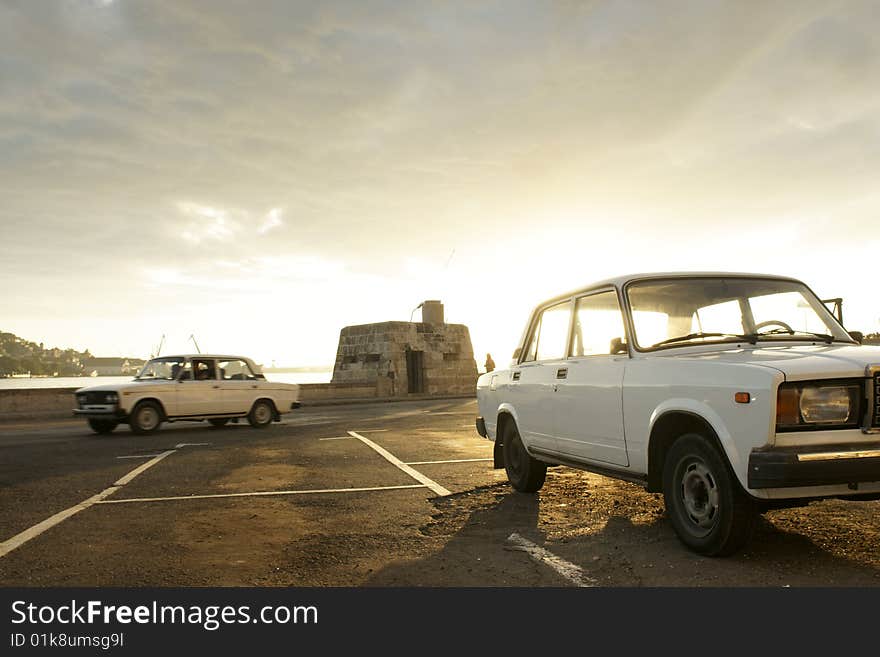 Dawn and vintage cars at Havana, Cuba