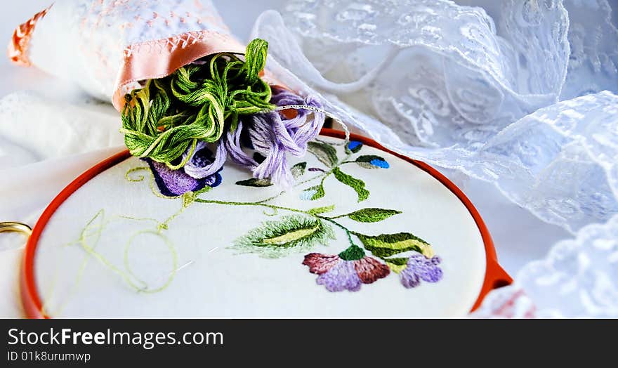 Still life with unfinished embroidery, threads and lace. Still life with unfinished embroidery, threads and lace