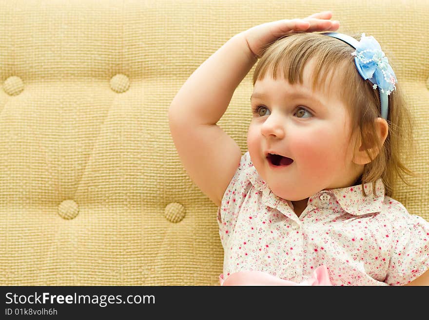 Funny baby sits on sofa. Funny baby sits on sofa