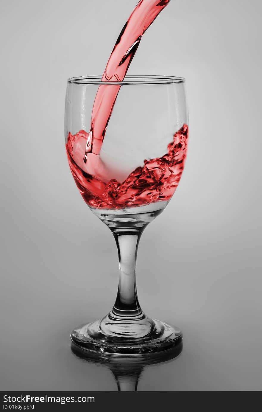 Glass of pouring water with wine