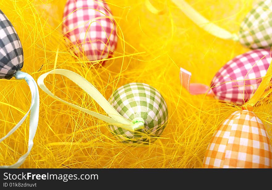 Colored different eggs on yellow background