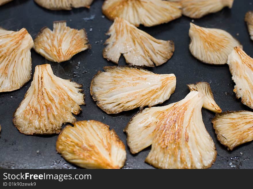 The brilliant yellow mushrooms in the iron preparing to eat