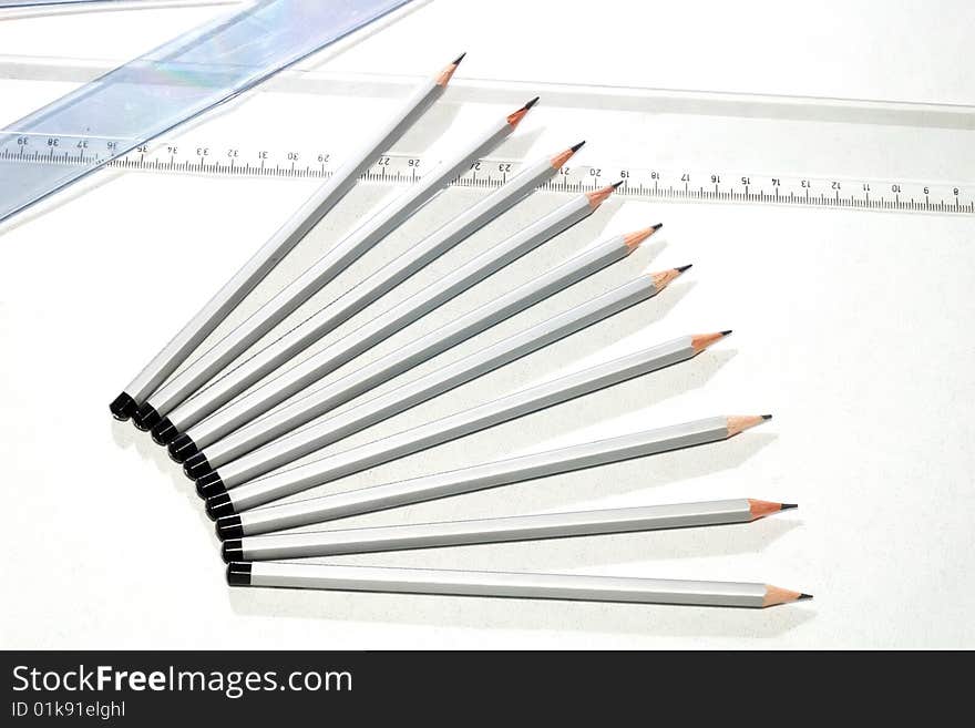 A set of drawing pencils and a rulers