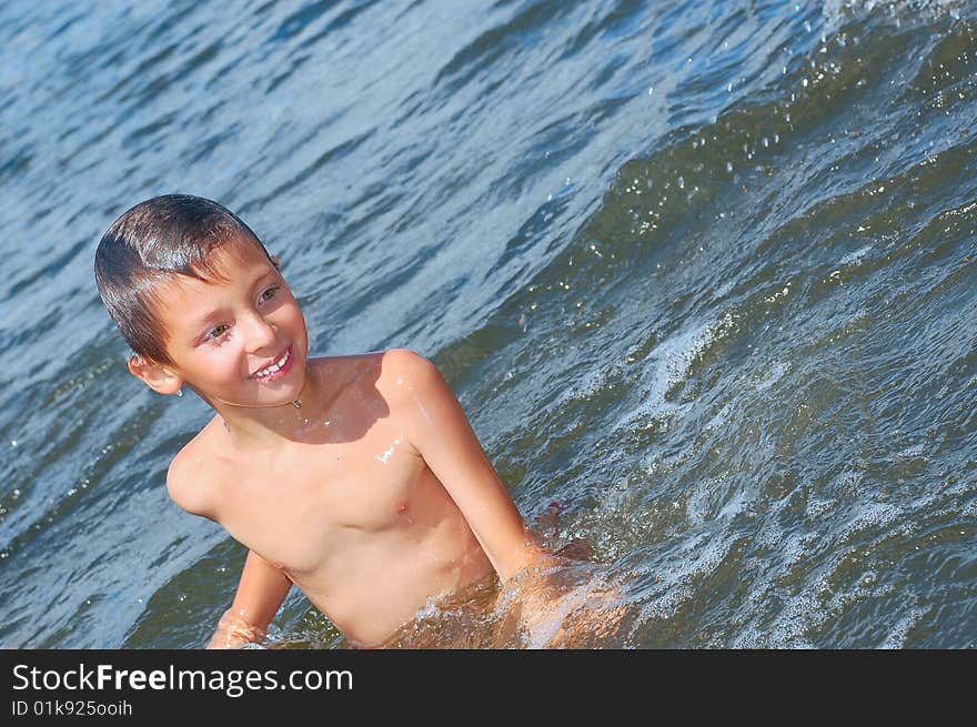 Happy boy having fun in the river water. Happy boy having fun in the river water