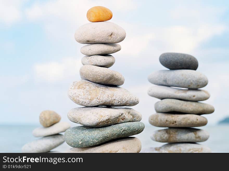 Three stone tower built of colored pebbles. Three stone tower built of colored pebbles