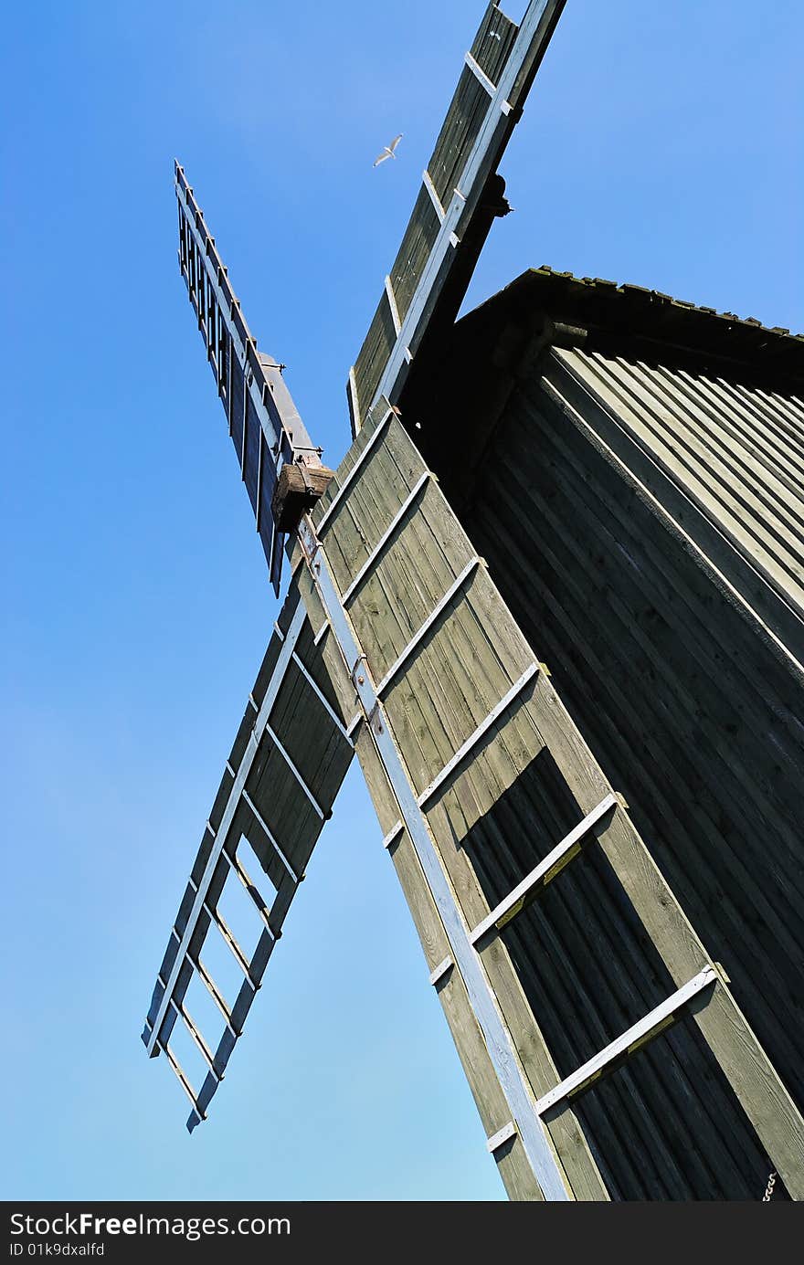 Old wooden windmill and the blue sky