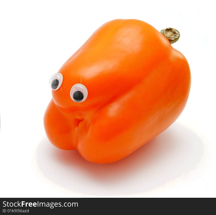 Sweet orange bell pepper with eyes on white background. Sweet orange bell pepper with eyes on white background