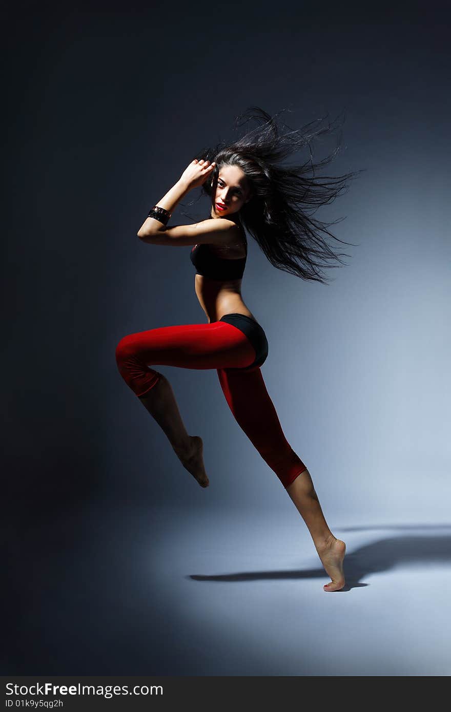 Modern style dancer posing behind studio background. Modern style dancer posing behind studio background