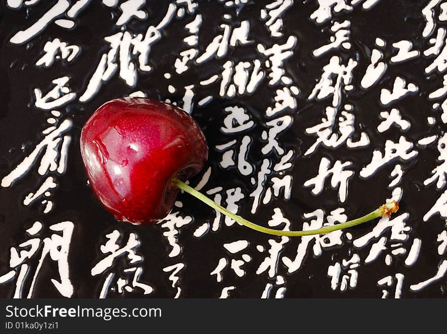 Lone cherry fruit on the japanese styled plate