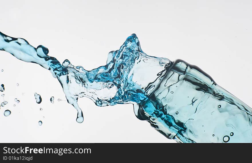 Bottle and creative splashing water.

Isolated on white