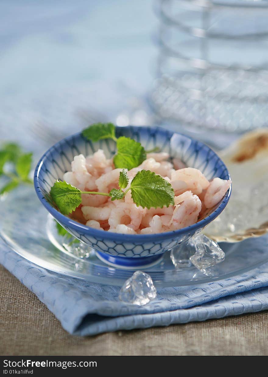 Fresh raw prawns in blue bowl