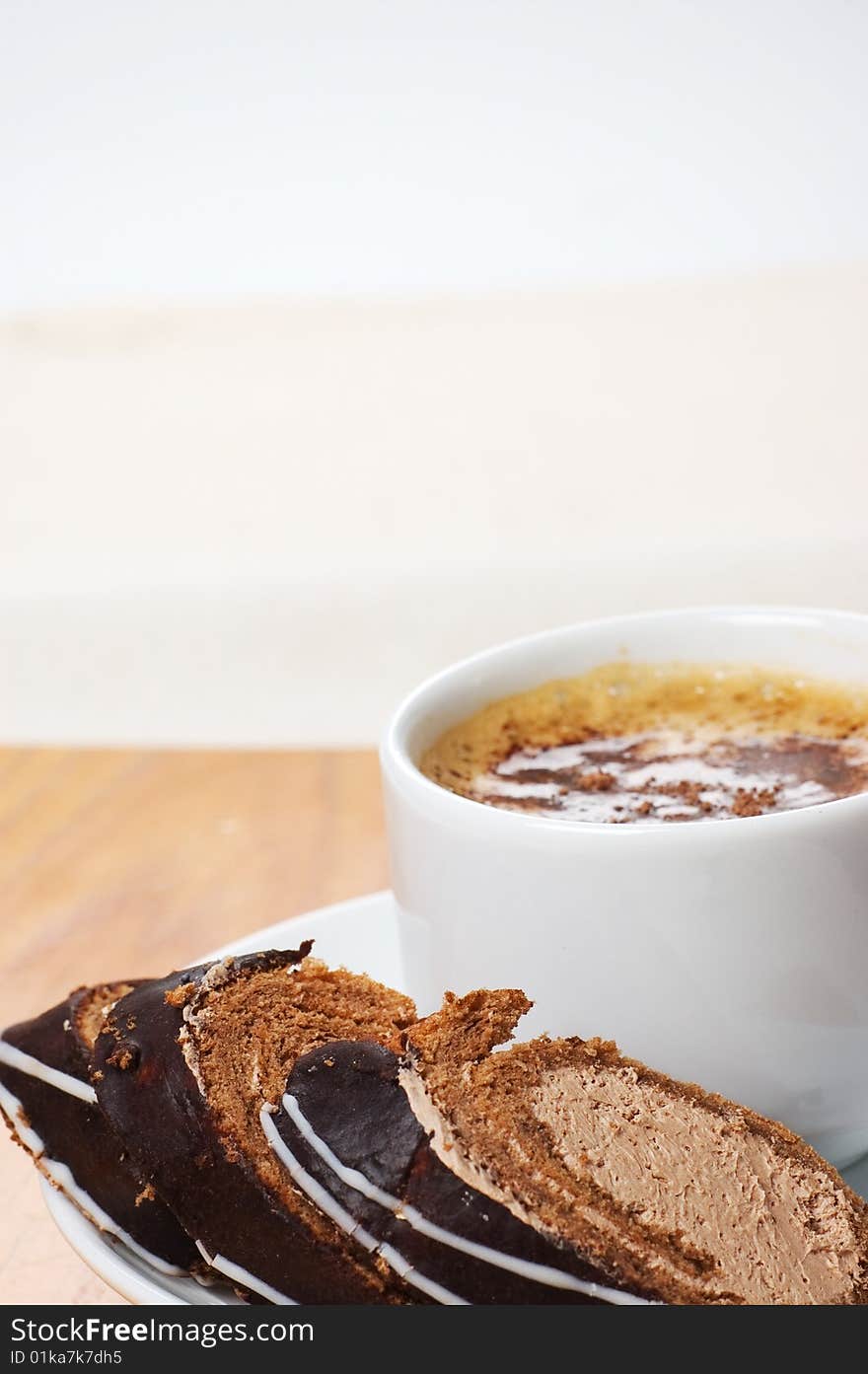 Close-up cup of coffee with dessert on the light background