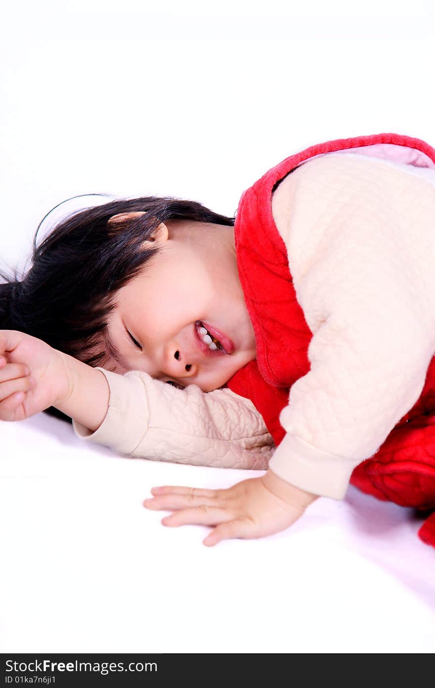 A picture of a little chinese girl laughing happily on the ground