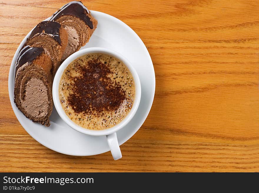 Close-up  cup of coffee with dessert on the wooden table