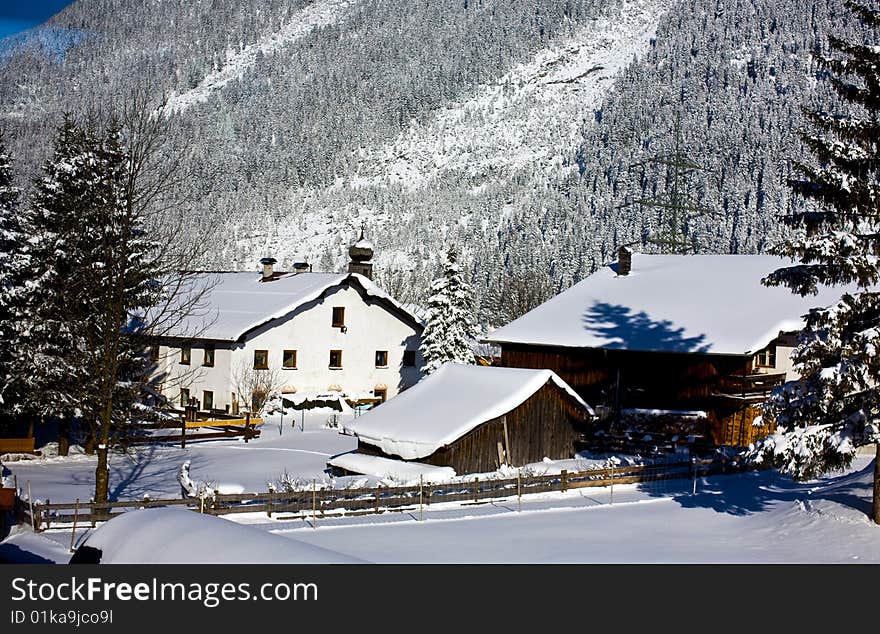 German homestead nestled at the bottom of the Alps