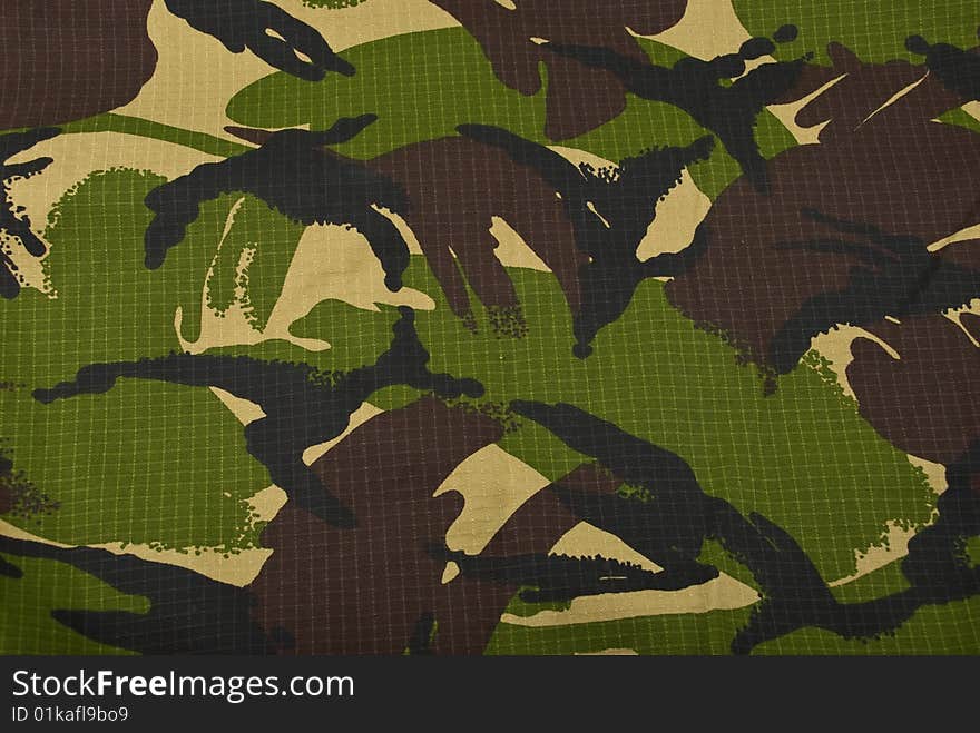 Combat camouflage cloth in green and beige background,check also Camouflage