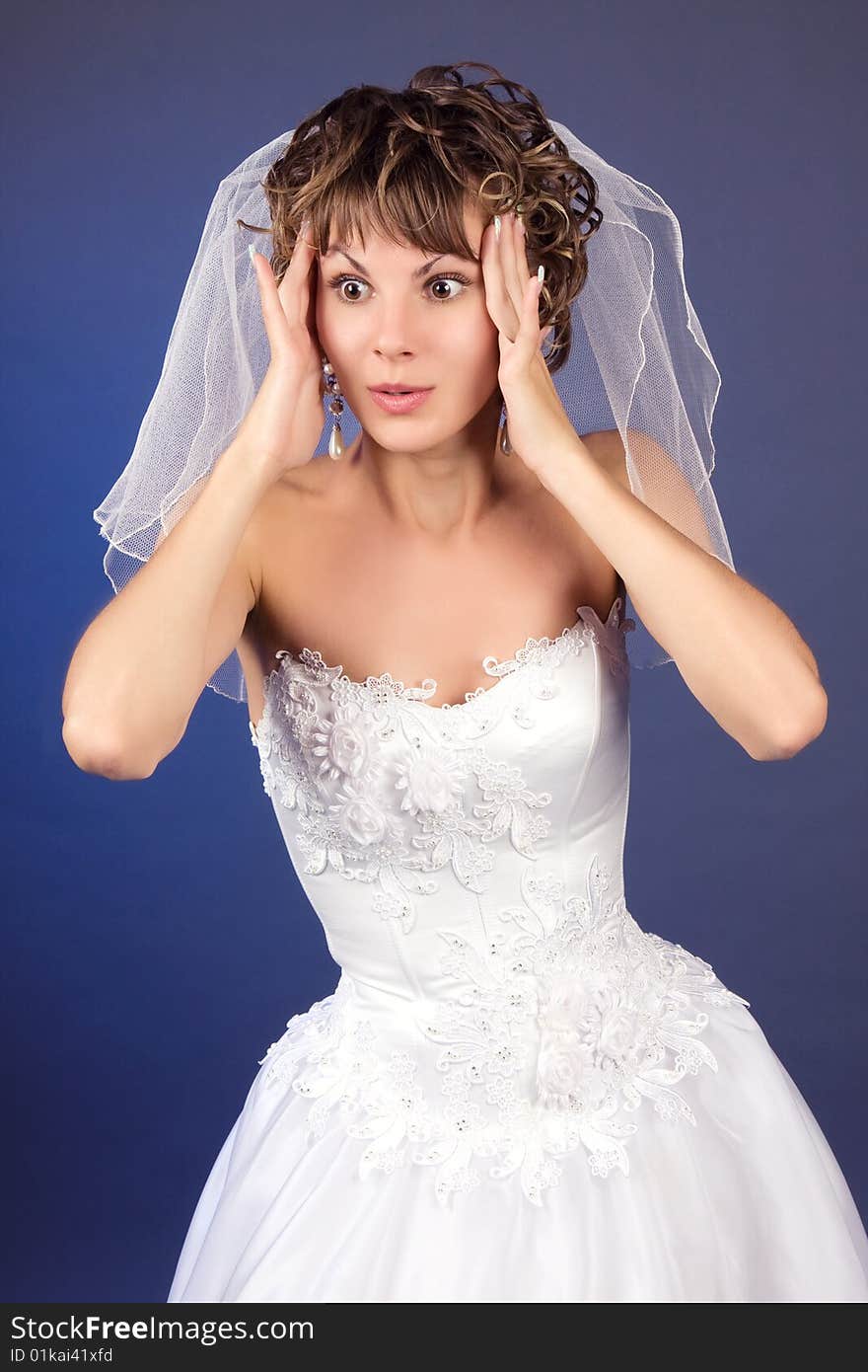 Studio portrait of the surprised young bride