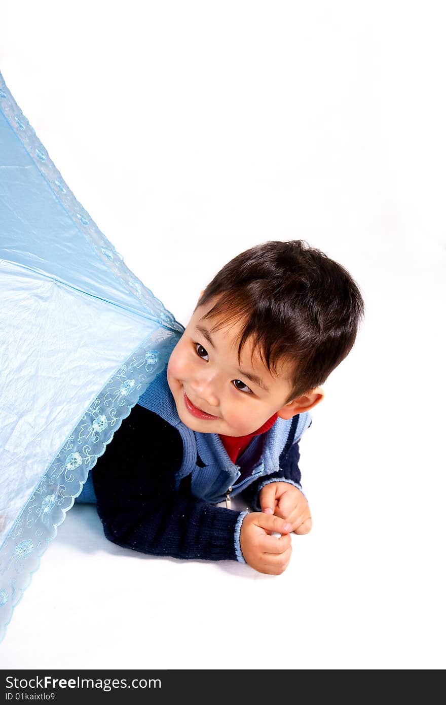 A picture of a little chinese boy hiding behind a light-colored umbrella. A picture of a little chinese boy hiding behind a light-colored umbrella