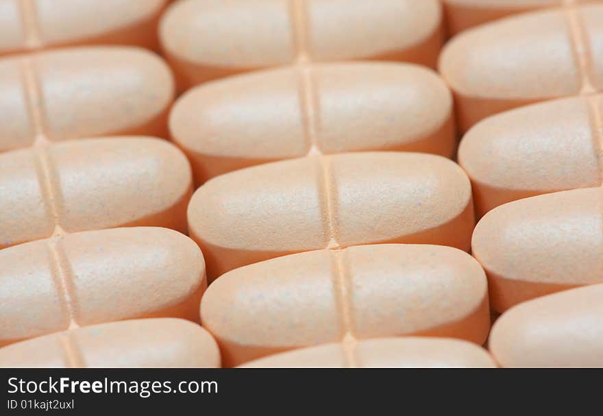 Closeup of orange pills on the table