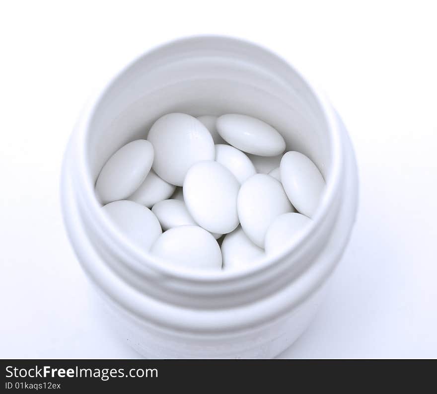 White tablets in container  in blue light