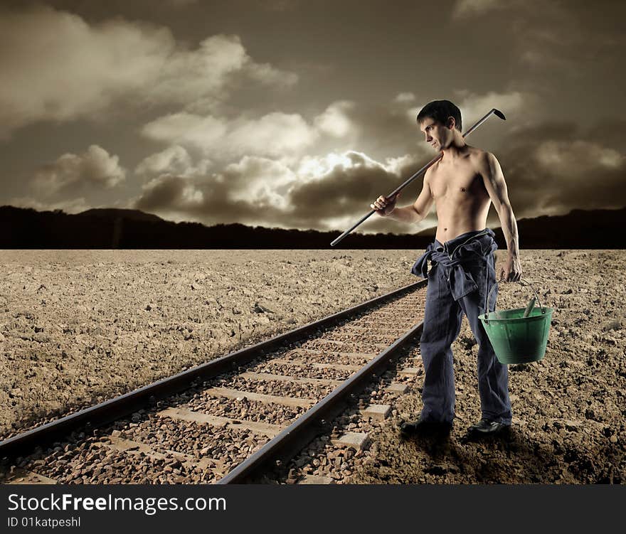 Worker with tools near the train tracks