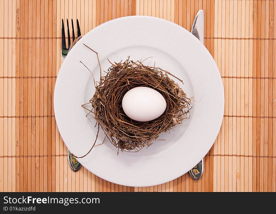 Egg in a nest served on a plate