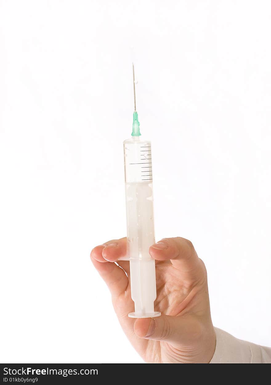 Medical syringe in front of a white background