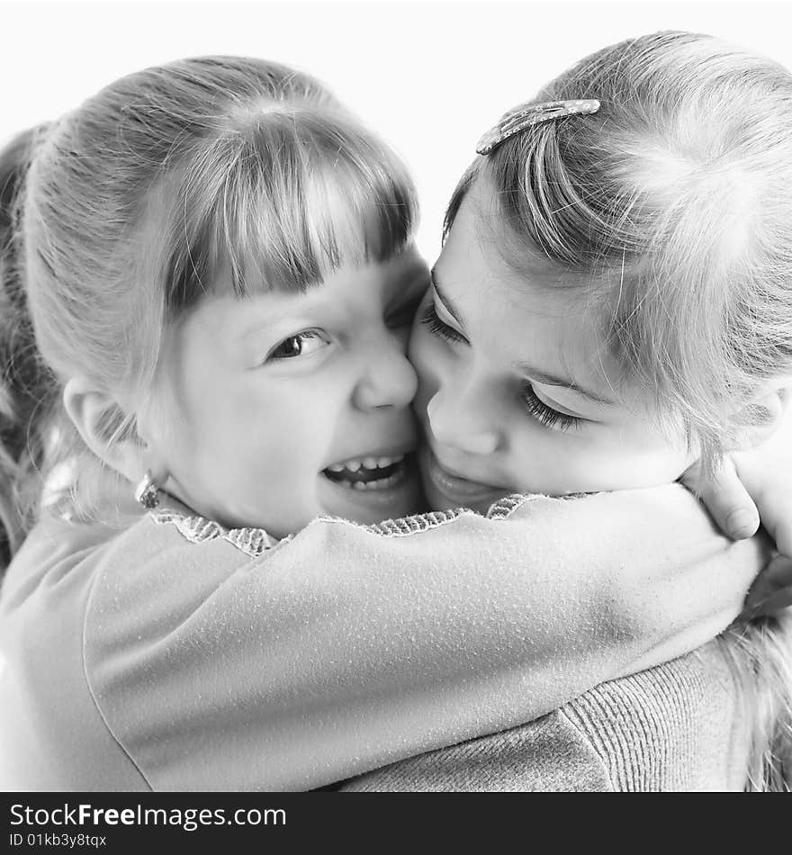 An image of two little sisters embracing closeup. An image of two little sisters embracing closeup